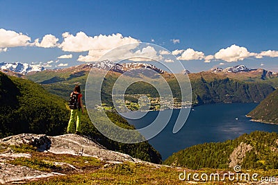 Backpacking young girl on lookout of Norwegian fjords and mountains, Norway Editorial Stock Photo