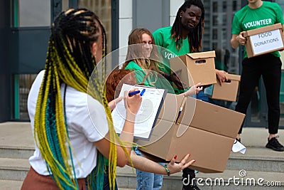 Active young people enjoys volunteering at food and clothes bank Stock Photo