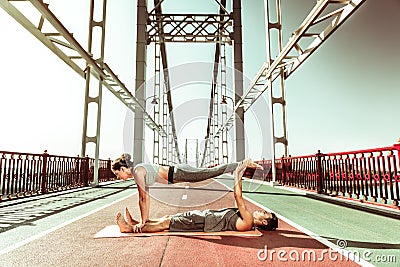 Active young people stretching and doing yoga asanas Stock Photo