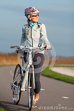 Active young woman with her bicycle Stock Photo