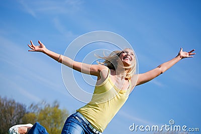 Active young woman jumping high in sunshine Stock Photo
