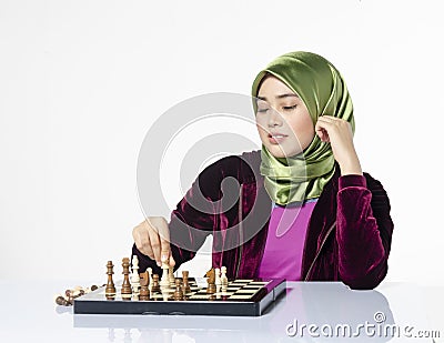 Active young woman playing chess over white background Stock Photo