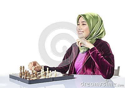 Active young woman playing chess over white background Stock Photo