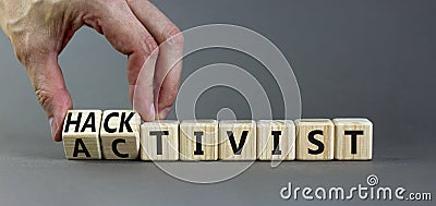 Activist or hacktivist symbol. Businessman turns wooden cubes and changes the word Activist to Hacktivist. Beautiful grey table Stock Photo