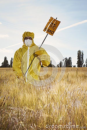 Activist protesting against genetically modified cereals on field Stock Photo