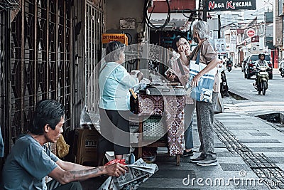 Bogor, Indonesia, 1st September 2024: people passing by on the sidewalk filled with street vendors Editorial Stock Photo