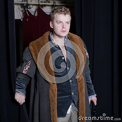 Actor dressed historical costume in interior of old theater. Stock Photo