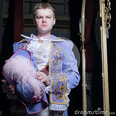 Actor dressed historical costume in interior of old theater. Stock Photo