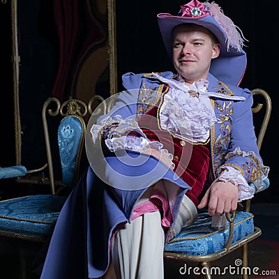 Actor dressed historical costume in interior of old theater. Stock Photo