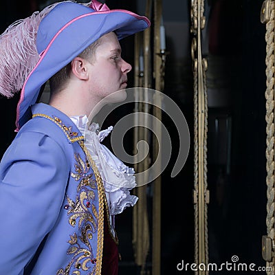 Actor dressed historical costume in interior of old theater. Stock Photo