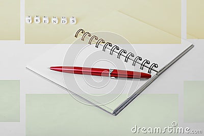 Actual trends. Notepad and pen. Letters on a white surface Stock Photo