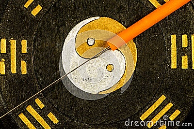 Acupuncture needle on Chinese Taoism symbol Stock Photo