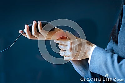 Acute pain in a business woman wrist, colored in red on dark blue background, Health issues problems Stock Photo