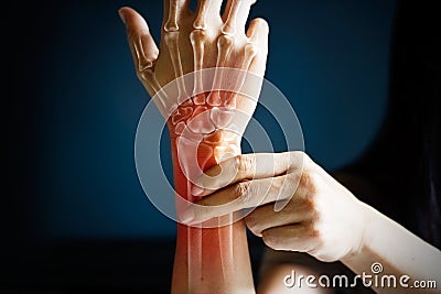 Acute pain in a woman wrist, colored in red on dark blue background. Health issues problems Stock Photo