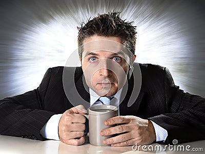 Addict businessman holding cup of coffee anxious and crazy in caffeine addiction Stock Photo