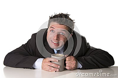Addict businessman in suit and tie holding cup of coffee as maniac in caffeine addiction Stock Photo