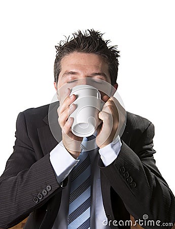 Addict businessman in suit and tie holding cup of coffee as maniac in caffeine addiction Stock Photo