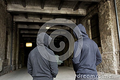 Addict men or criminals in hoodies on street Stock Photo