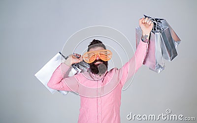 Addicted consumer concept. Man bearded hold shopping bags. Shopping dumb wasting money. Stupid things you do with your Stock Photo