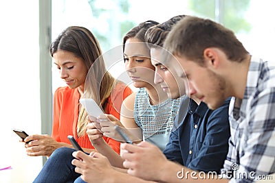 Addicted group of friends using their smart phones Stock Photo