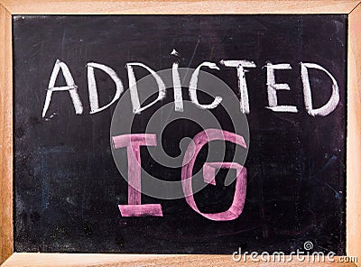 Addicted IG word on blackboard Stock Photo