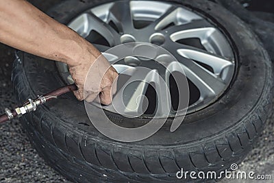 Adding air pressure into a newly vulcanized tire. Attaching an air hose into the valve stem Stock Photo