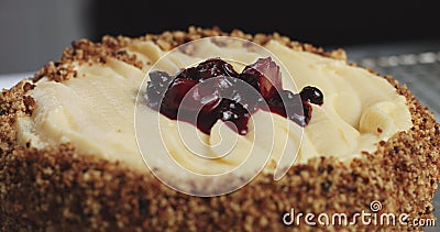 Adding cream and fruit to cake Stock Photo