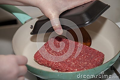 Adding More Ground Beef Stock Photo