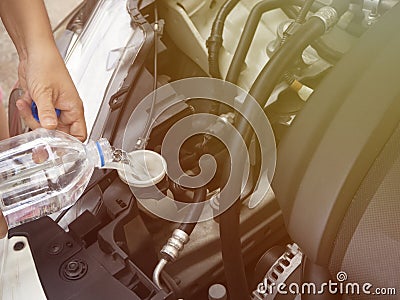 Adding water to the car radiator Stock Photo