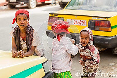 Three small orphan street kids playing and laughing on a quite c Editorial Stock Photo