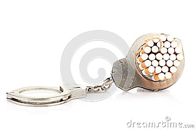Addition concept with cigarettes and handcuffs Stock Photo