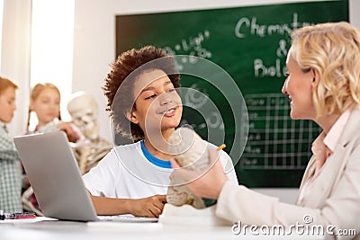 Delighted positive boy having a tutoring lesson Stock Photo