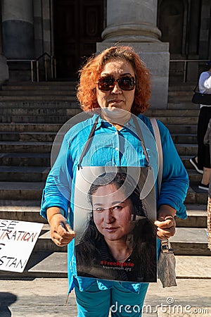 Pro-Uyghur demonstrator holding an image of Rahile Dawut Editorial Stock Photo