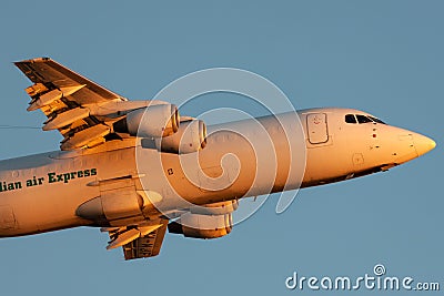 Australian Air Express National Jet Systems British Aerospace 146-300 aircraft VH-NJF taking off from Adelaide Airport at sunset Editorial Stock Photo