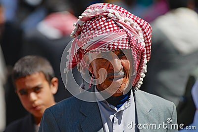 Portrait of unidentified senior man wearing traditional head scarf at the street in Aden, Yemen. Editorial Stock Photo