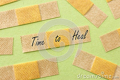 Adhesive bandage plasters and the text time to heal Stock Photo