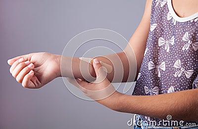 Adhesive plaster bandage on childen arm wound Stock Photo