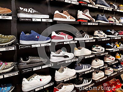 Adidas, Puma sport shoes in row at local mall. Editorial Stock Photo