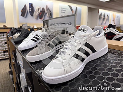 Adidas sports shoe display on the store shelf Editorial Stock Photo