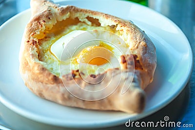 Adjarian khachapuri with eggs on the table Stock Photo