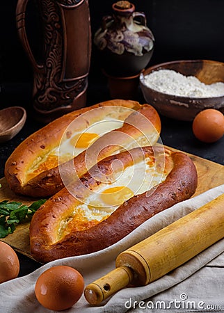 Adjarian khachapuri on a wooden Board. Homemade cake Stock Photo