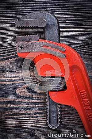Adjustable monkey wrench on wooden board top view plumbing conce Stock Photo