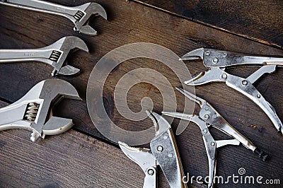 Adjustable wrench or spanner wrench and Locking pliers on wooden background, Prepare basic hand tools for work Stock Photo