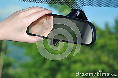 Adjusting rear view mirror Stock Photo