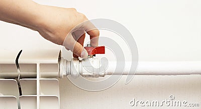 Adjustment of comfortable temperature on the wall radiator in the house. Saving energy resources, increasing the price of gas Stock Photo
