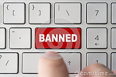 admin bans the user. red button on the keyboard of a notebook with the inscription of banned. concept of blocking in the Internet Stock Photo