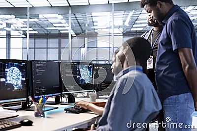 Admin doing brainstorming with colleagues in server farm, using AI Stock Photo