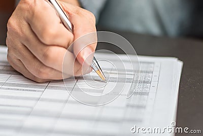 Administrator`s hand fill in business schedule form document writing on yearly work plan, monthly timetable sheet, or weekly time Stock Photo