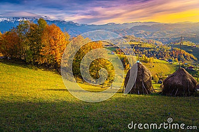 Admirable autumn countryside scenery with haystacks on the hills, Romania Stock Photo