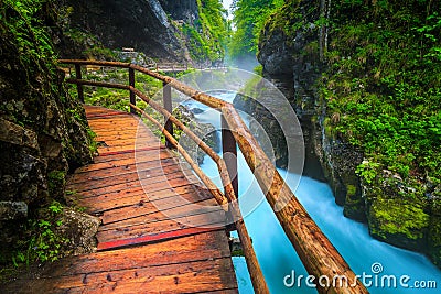 Noisy Radovna river in Vintgar gorge with wooden footbridge, Slovenia Stock Photo